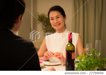 A middle-aged couple enjoying dinner at the restaurant A middle-aged couple enjoying dinner at the restaurant 27798698