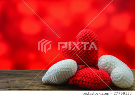 Red and white heart on wooden and red background 27799133