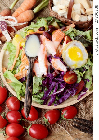 Fresh salad and egg with dressing delicious. 27800539