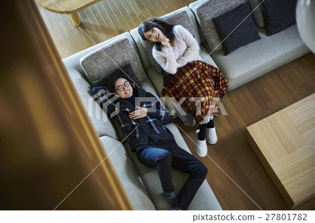 A couple relaxing at a villa vacation sofa 27801782