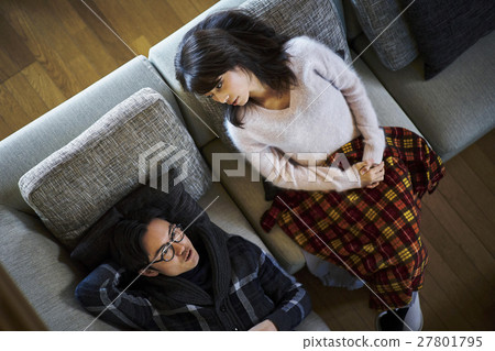 A couple relaxing at a villa vacation sofa 27801795