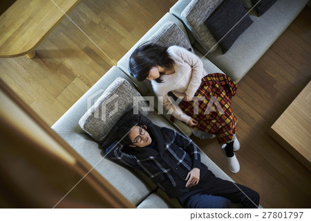A couple relaxing at a villa vacation sofa 27801797