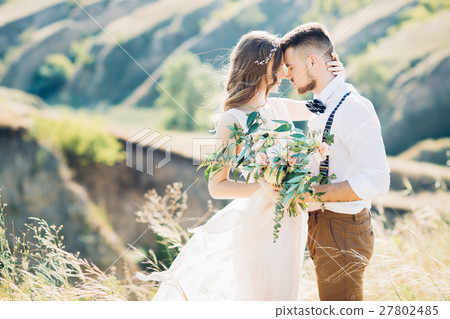 bride and groom hugging at the wedding in nature. 27802485