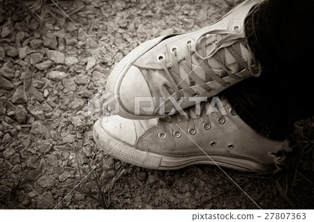 Old sneakers on the floor,sepia vintage tone. 27807363