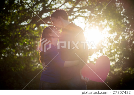 Loving couple. Beautiful young love couple holding paper hearts 27807422