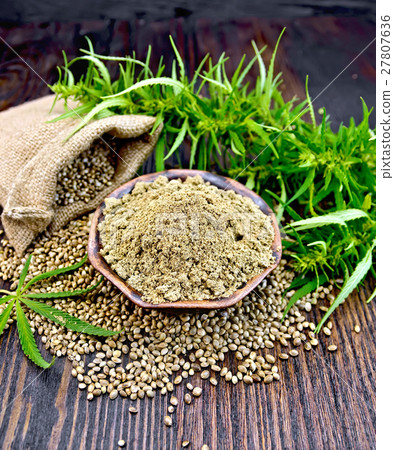 Flour hemp in bowl with grain in bag on board 27807636