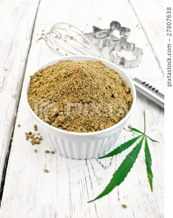Flour hemp in bowl with leaf on board Flour hemp in bowl with leaf on board 27807638