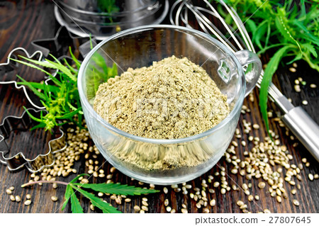 Flour hemp in glass cup with leaf on board 27807645