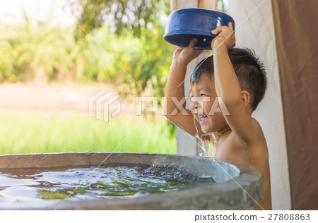 Asian Village poor boy is taking a bath Asian Village poor boy is taking a bath 27808863