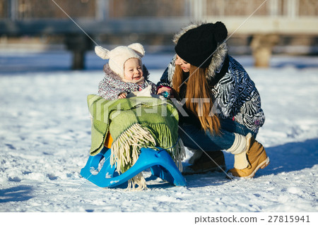 mother and daughter in winter outdoors 27815941