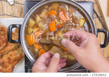 Chef putting Japanese curry pasted for cooking Chef putting Japanese curry pasted for cooking 27816652