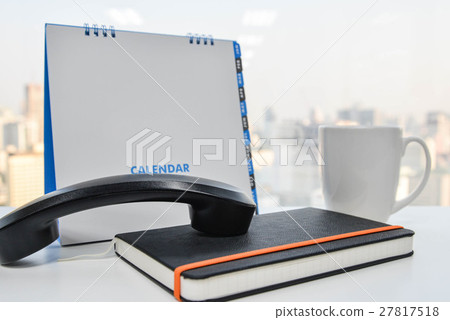 IP Phone handset on notebook  and cup of coffee 27817518