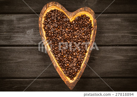Coffee beans in a heart shaped bowl 27818894