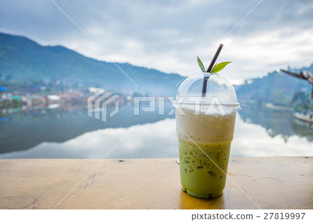 Milk green tea on the table riverside view Milk green tea on the table riverside view 27819997