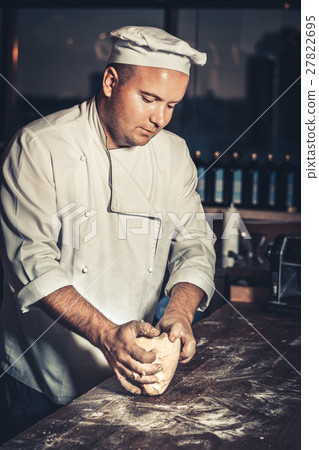 Busy chef at work in the restaurant kitchen Busy chef at work in the restaurant kitchen 27822695