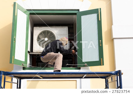 Man painting building window with paint prush Man painting building window with paint prush 27823754