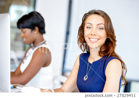 Portrait of businesswoman working at her desk in office Portrait of businesswoman working at her desk in office 27829451