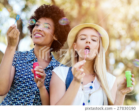 Two women friends in park Two women friends in park 27830190