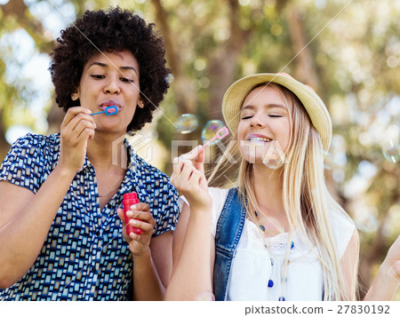 Two women friends in park Two women friends in park 27830192