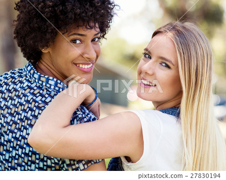 Two women friends in park Two women friends in park 27830194