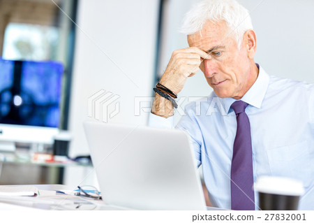 Businessman at the office tired Businessman at the office tired 27832001