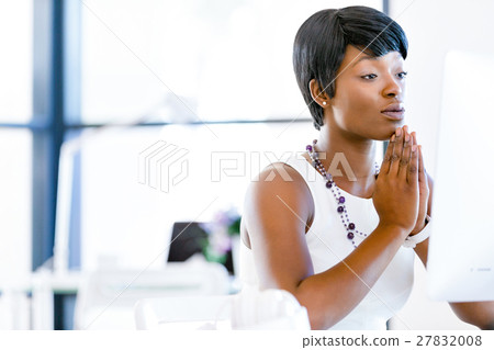 Young businesswoman sitting at desk and working Young businesswoman sitting at desk and working 27832008