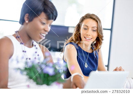Women working together, office interior Women working together, office interior 27832010