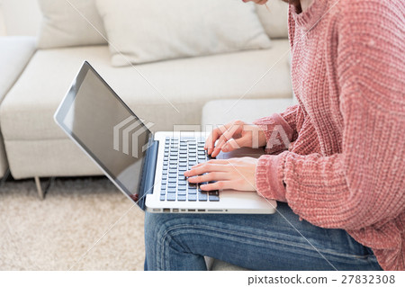 Woman hand watching personal computer in room 27832308