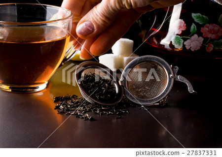 cup of tea with teapot on dark background cup of tea with teapot on dark background 27837331