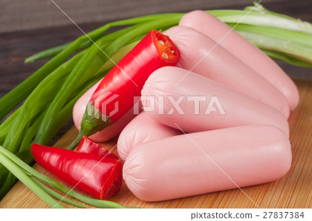 heap of sausages with spring onion and chilli on a heap of sausages with spring onion and chilli on a 27837384