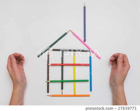 Female hand made of pencils on paper funny house 27839771