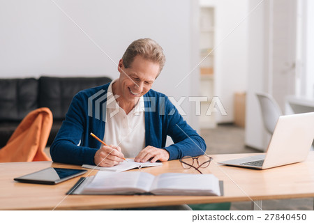 Handsome cheerful man holding a pencil 27840450
