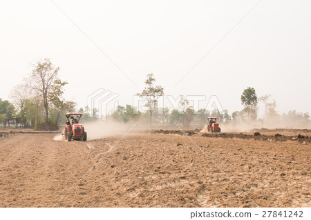 Tractor plows a field shoveling Tractor plows a field shoveling 27841242