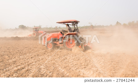 Tractor plows a field shoveling 27841244