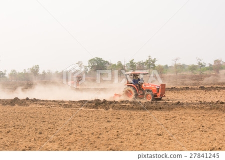 Tractor plows a field shoveling 27841245