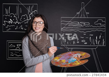 Positive woman painting a picture 27841434