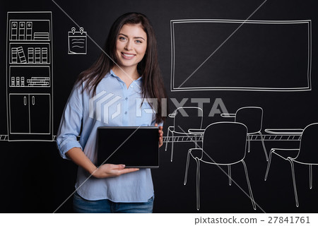 Cheerful professional teacher standing in the 27841761