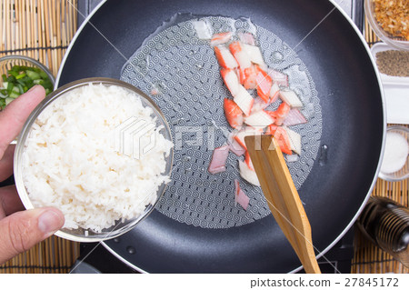 Chef put cooking rice to pan Chef put cooking rice to pan 27845172