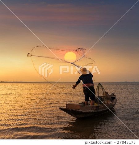 Fisherman on wooden boat throwing a net Fisherman on wooden boat throwing a net 27845173