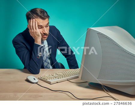Sad Young Man Working On computer At Desk Sad Young Man Working On computer At Desk 27846636