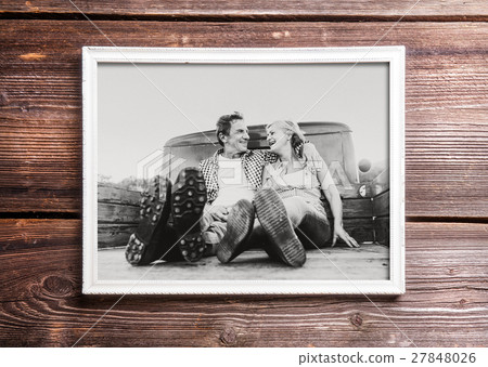 Photo of seniors in picture frame laid on wooden 27848026