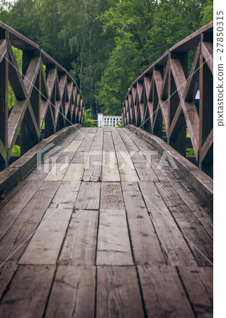 lovely wooden bridge over a creek in the park 27850315