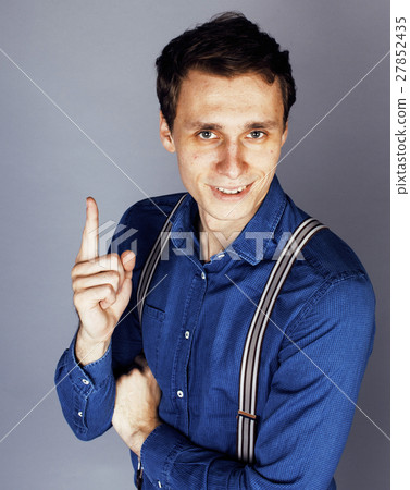 young goofy man with pimples pointing in studio young goofy man with pimples pointing in studio 27852435