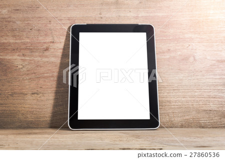 Image of a black digital tablet computer with white screen on old wooden desk, clipping path inside Image of a black digital tablet computer with white screen on old wooden desk, clipping path inside 27860536