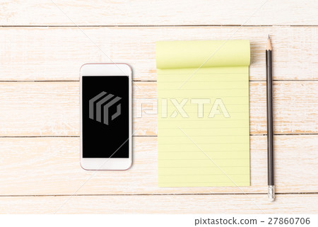 White paper with smart phone on wooden table White paper with smart phone on wooden table 27860706