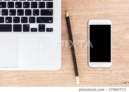Laptop and smart phone on office desk Laptop and smart phone on office desk 27860713