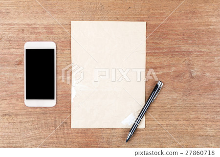 White paper with smart phone on wooden table White paper with smart phone on wooden table 27860718