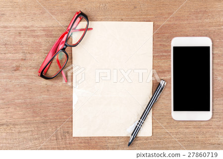 White paper with smart phone on wooden table White paper with smart phone on wooden table 27860719