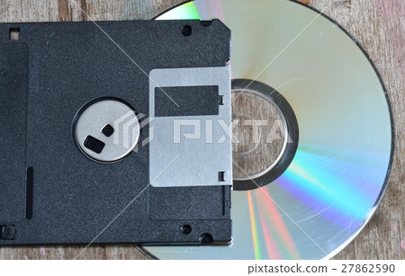 floppy disk and compact disc on wood board 27862590