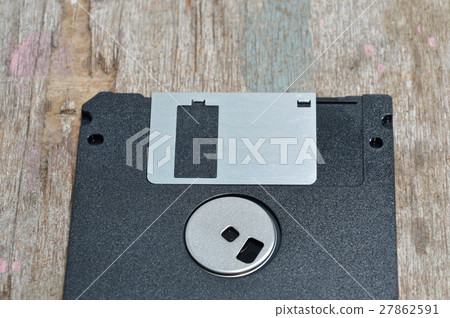 diskette on wooden board 27862591